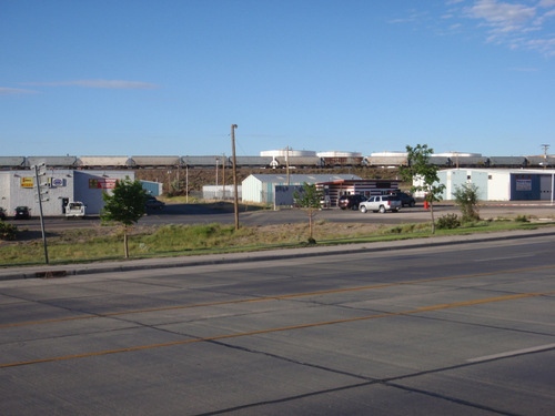 Cedar Street (main street), lookig southwest at oil tanks and railroad tracks.